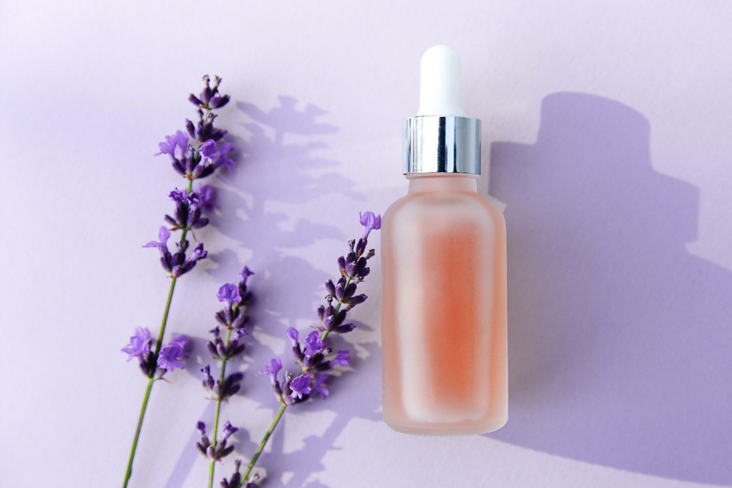 Lavender aromatherapy bottle on a purple background