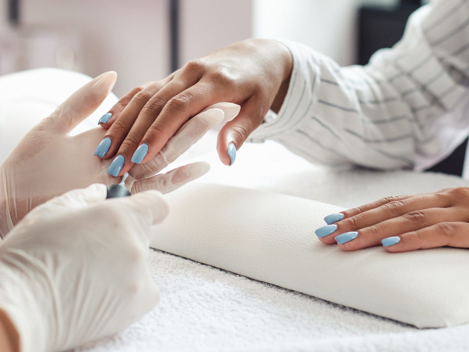 woman getting a manicure with acrylic nails