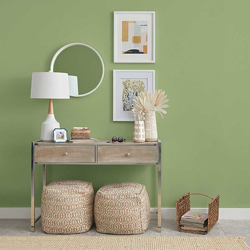 Green paint in room with side table and baskets