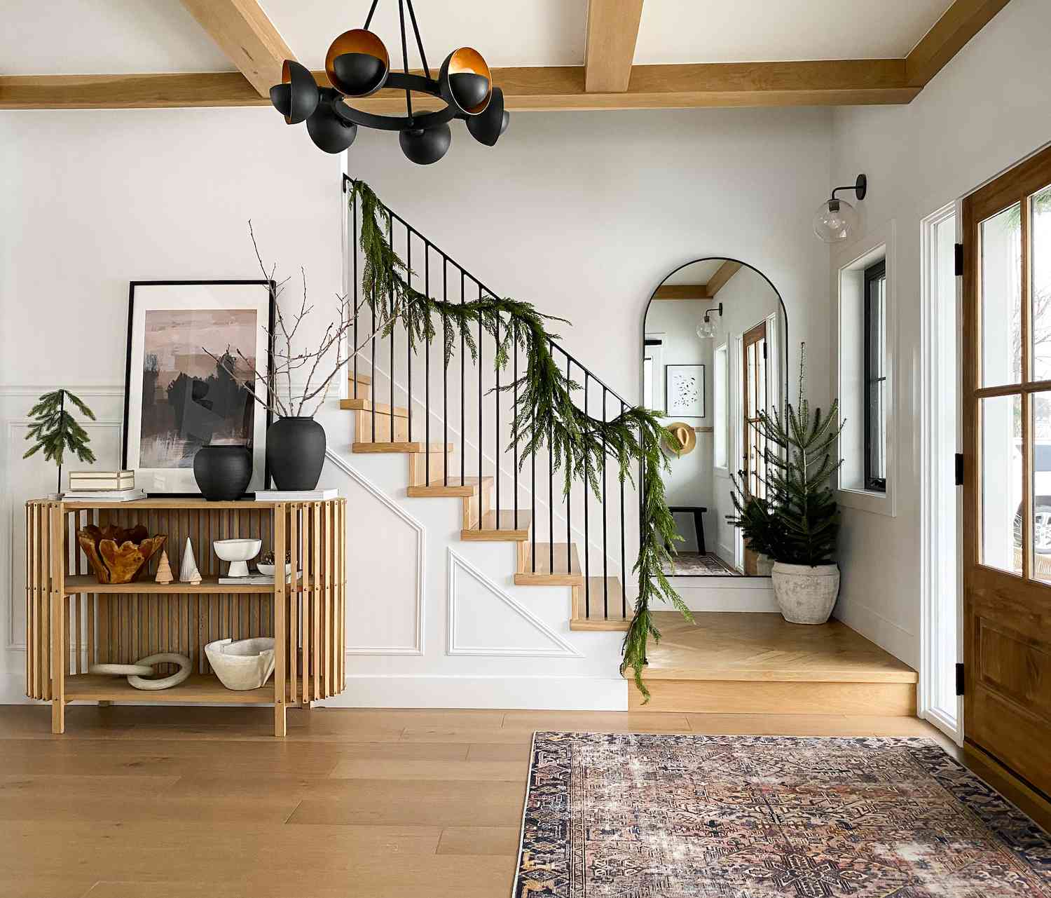 Entryway with holiday garland on stair banister