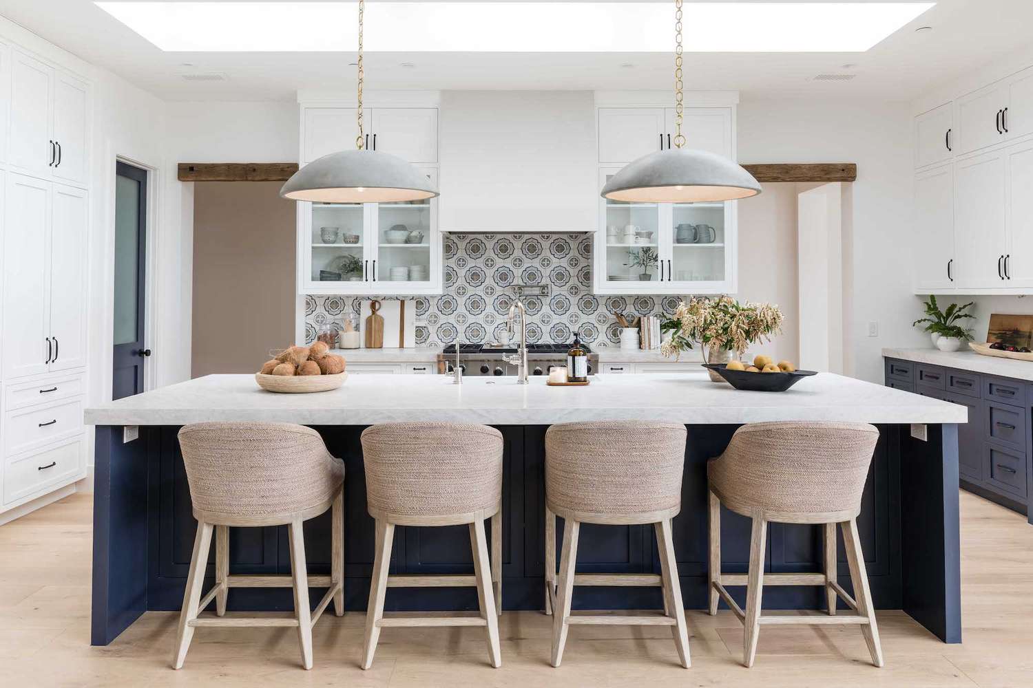 Kitchen with long island, hanging pendant lights and tile