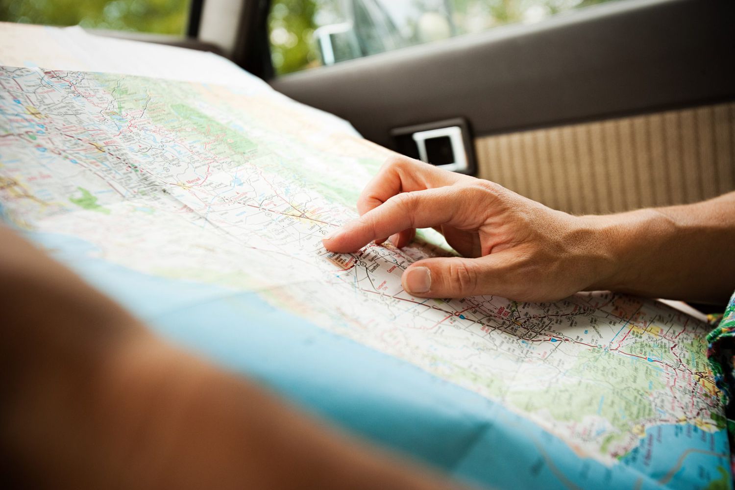 An image of a hand pointing to a map.
