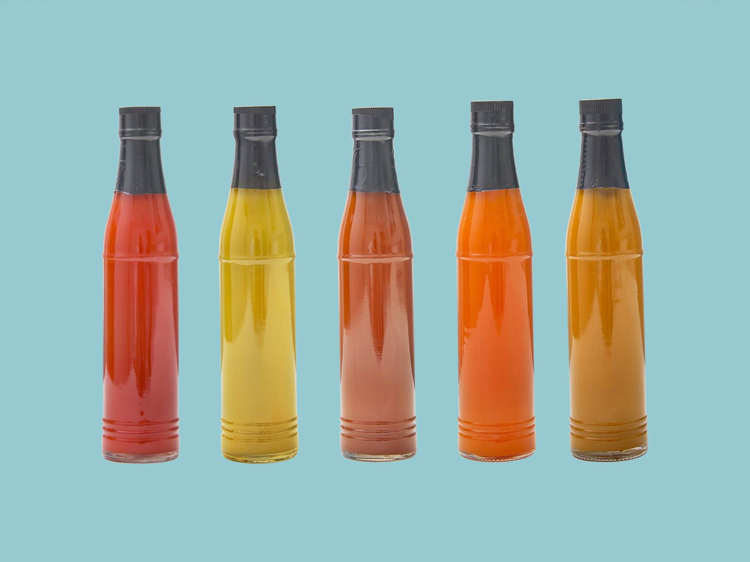 Set of glass bottles with delicious sauces
