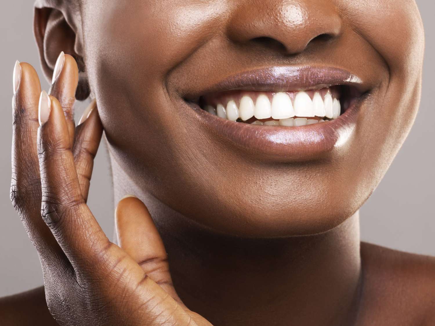 close of black woman smiling with perfect white teeth