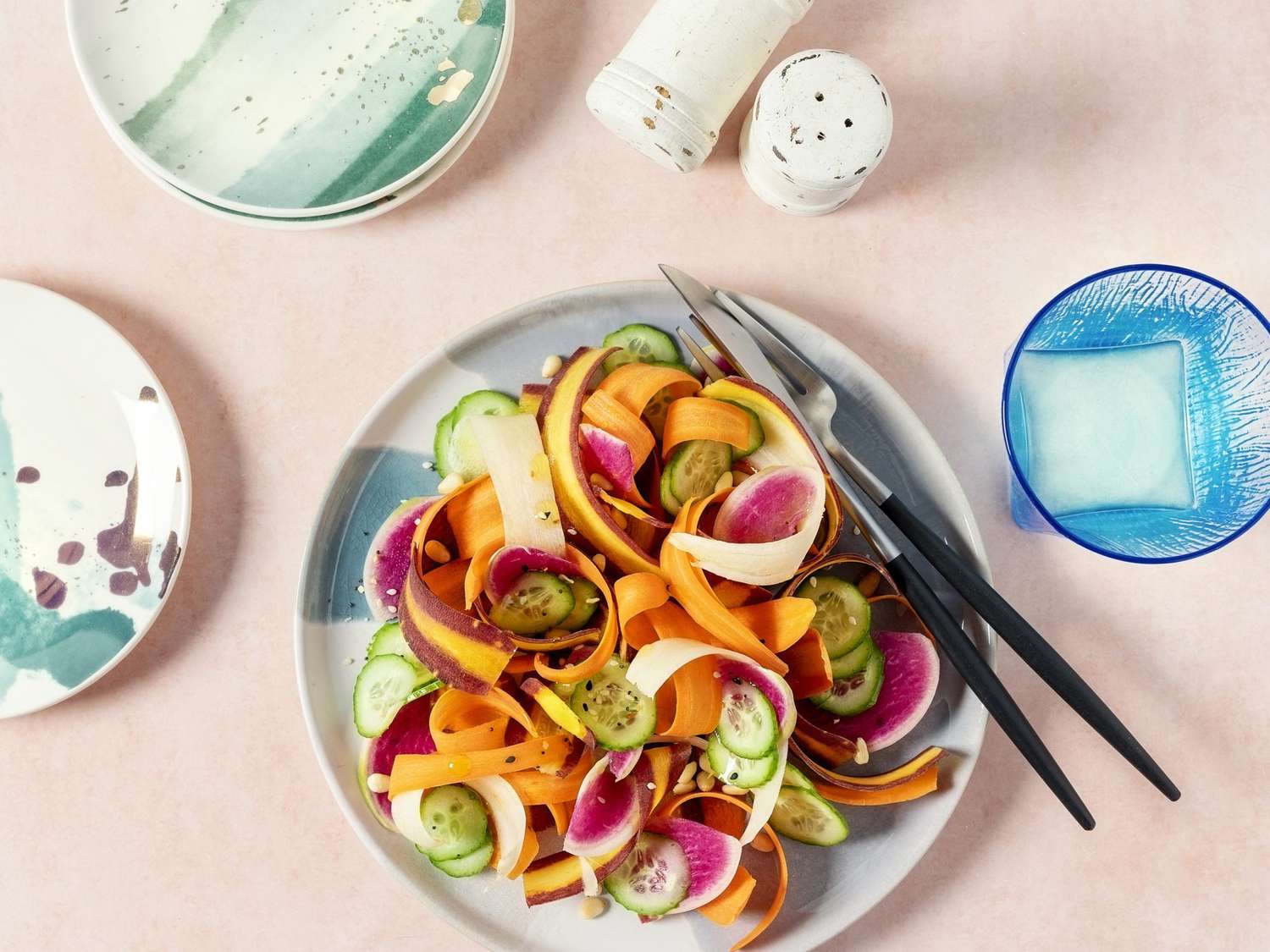 Plate of fresh salad on peach background