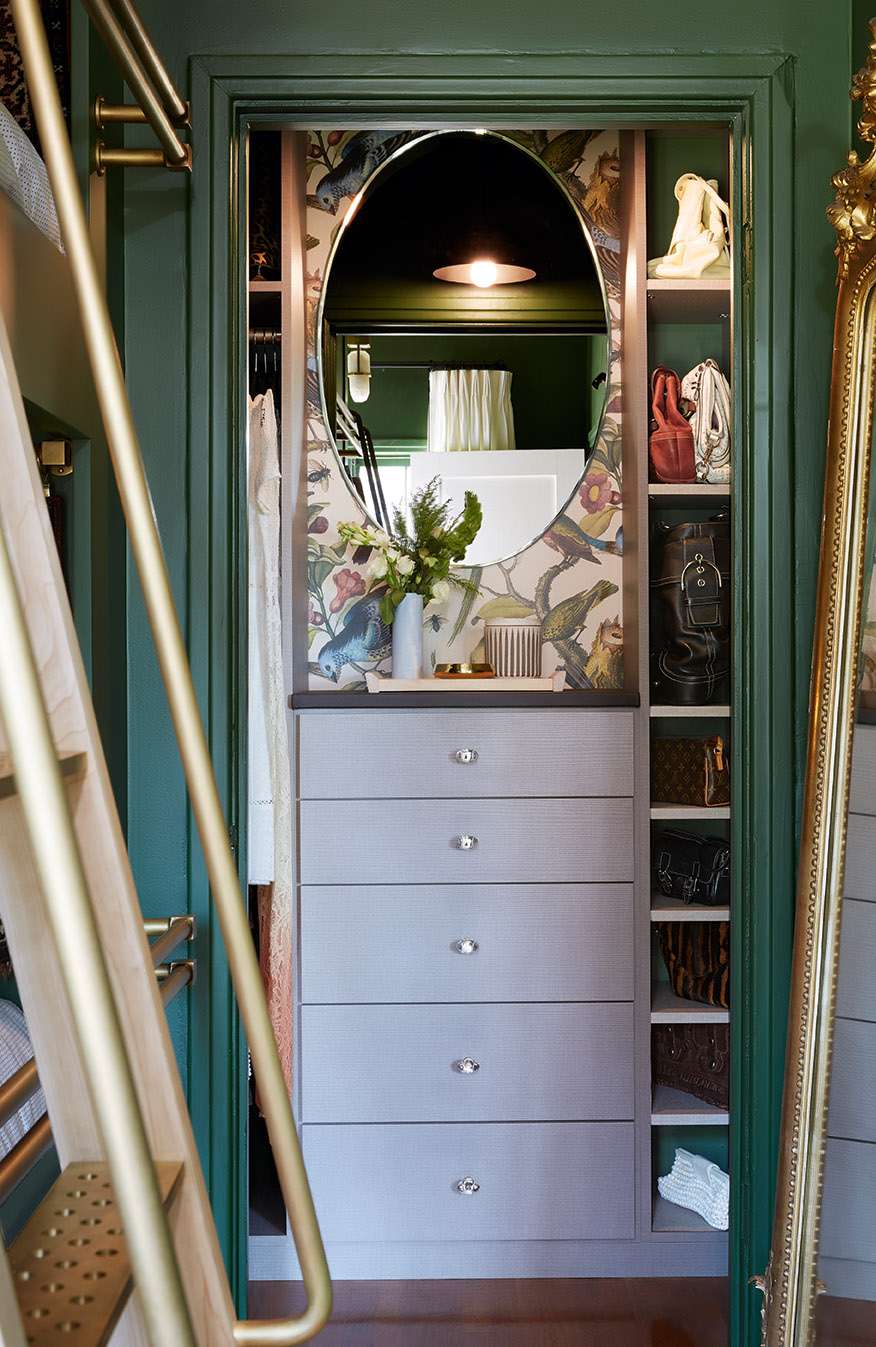 closet alcove with dark sage green paint and botanical wallpaper