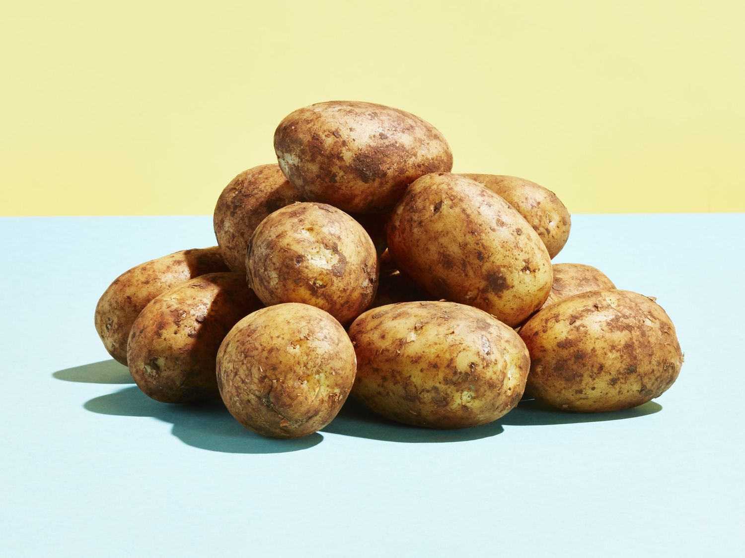 A pile of potatoes on a table top