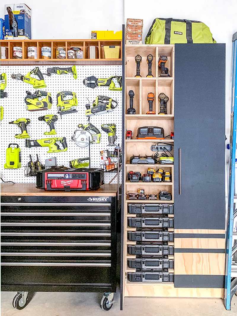 Pegboard with power tools, cubbies, and pull-out drawers in garage