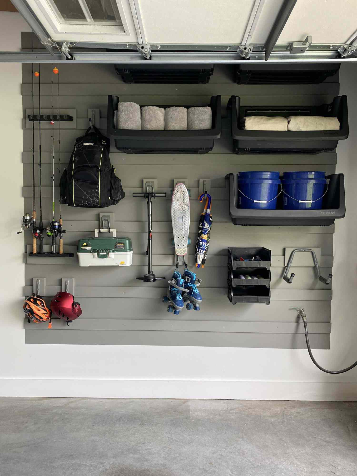 Gray wall with storage for equipment and home supplies