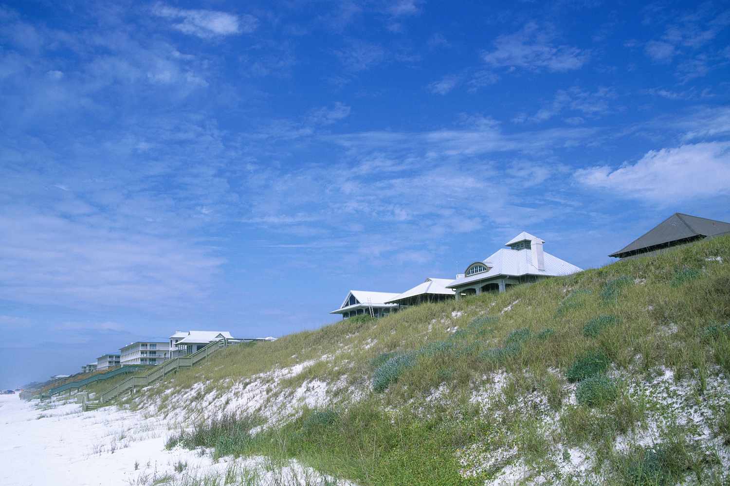 sandy dunes with grasses and houses in Rosemary Beach, Florida