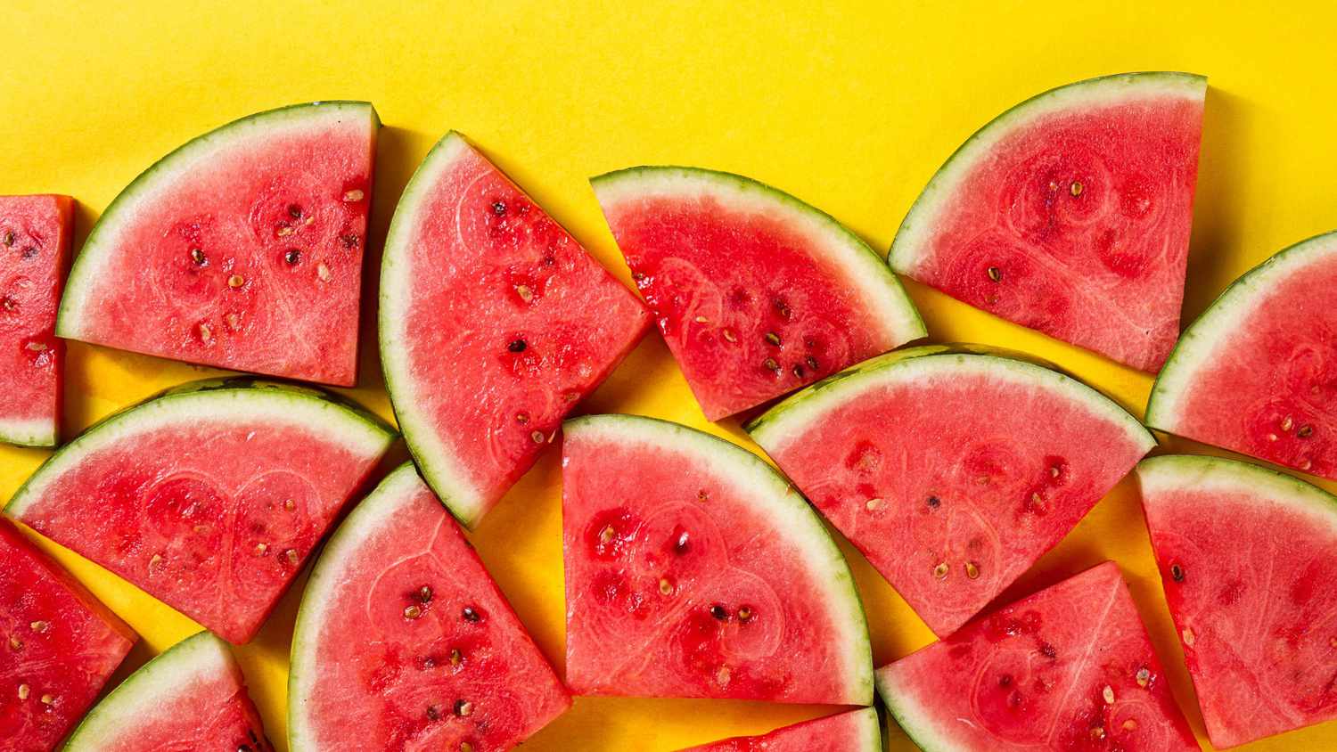 Beautiful pattern with fresh watermelon slices on yellow bright background. Top View.
