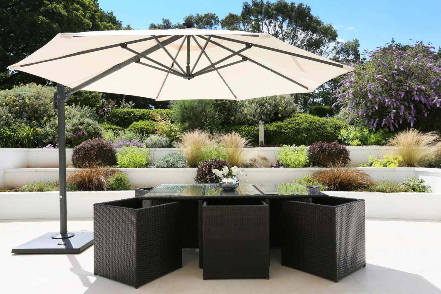 A cantilevered ivory-colored umbrella over a seating space on a patio