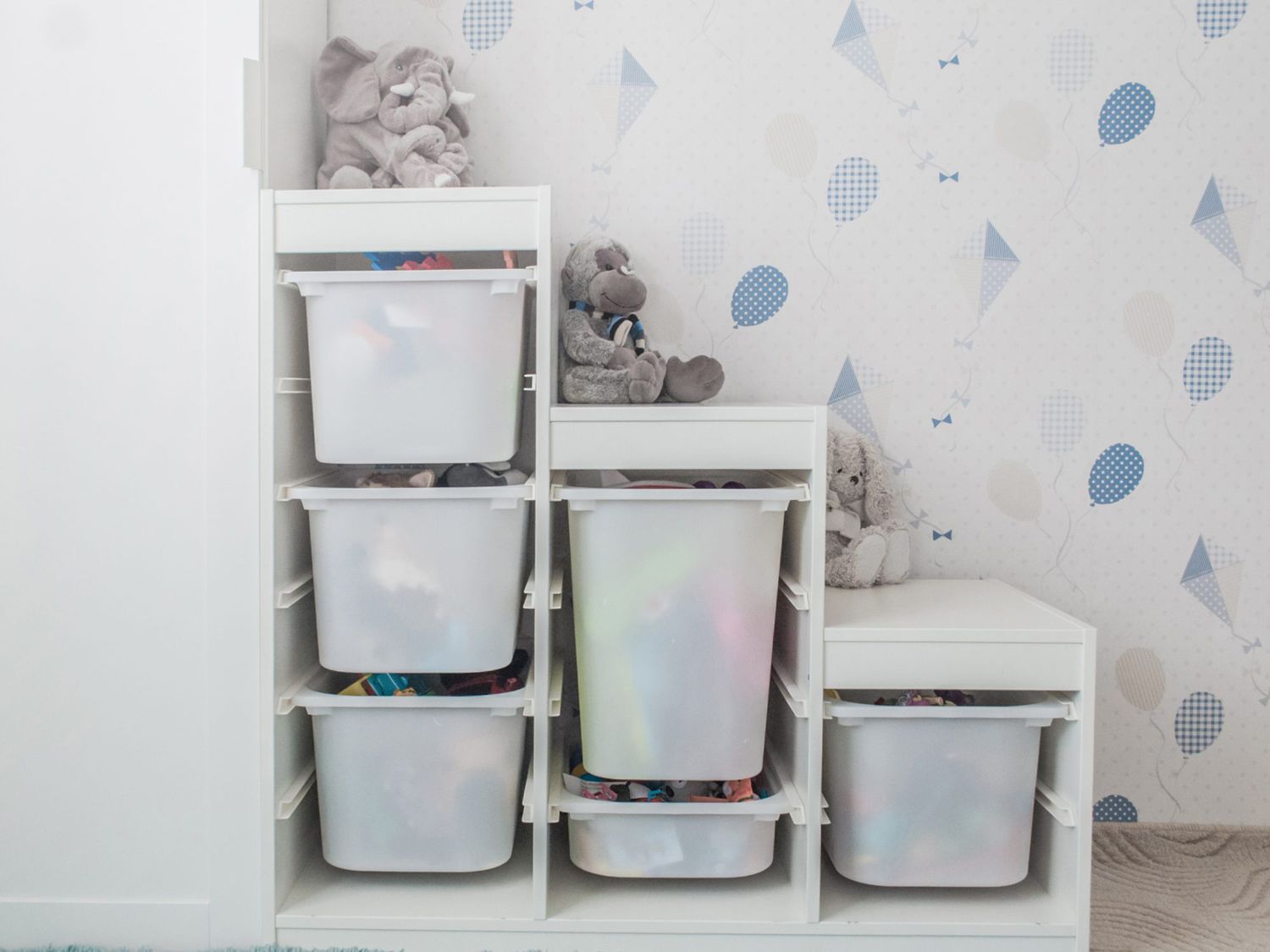 White toy storage rack in childrens's room.