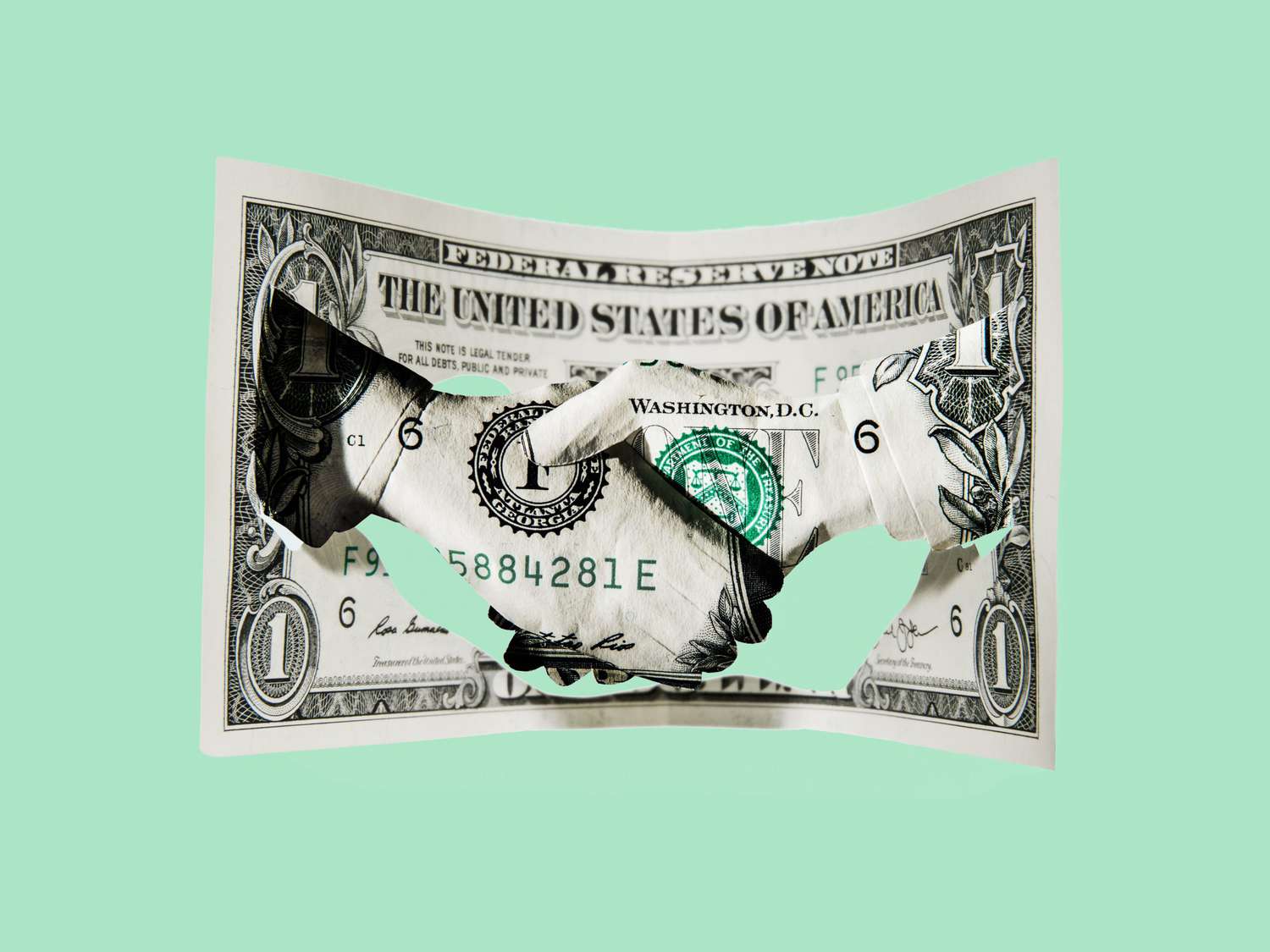 Paper-cut dollar - Handshake with single dollar.