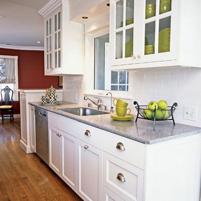 classic, white kitchen cabinets with gray marble countertops and glass panes in the upper cabinets