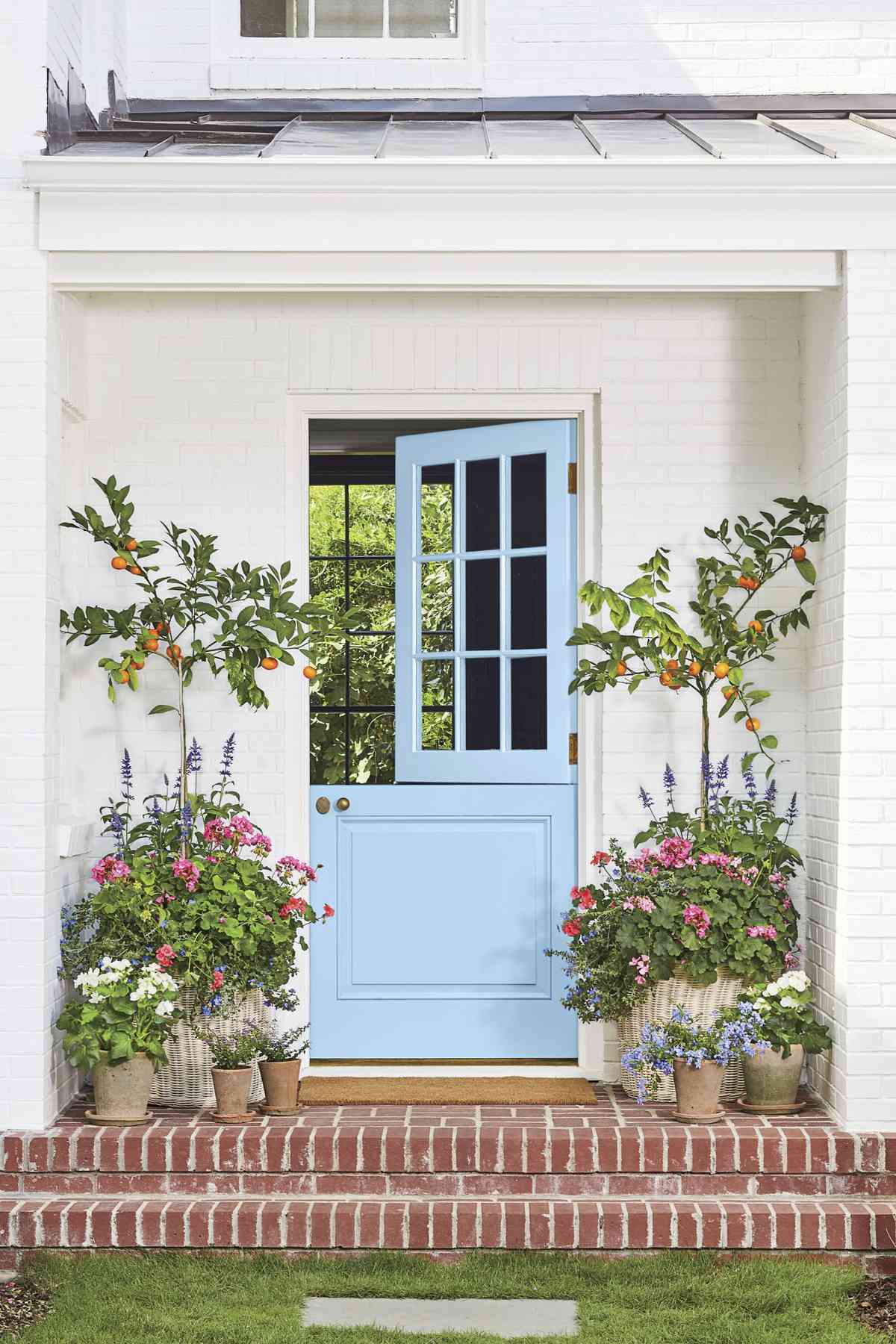 Blue Skies Front Door with Orange Trees and Flowers