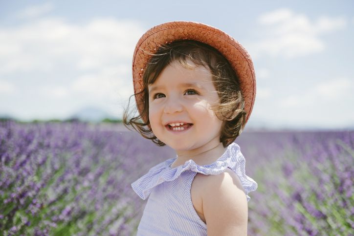 France, Provence, Valensole plateau, Happy toddler girl in purple lavender fields in the summer