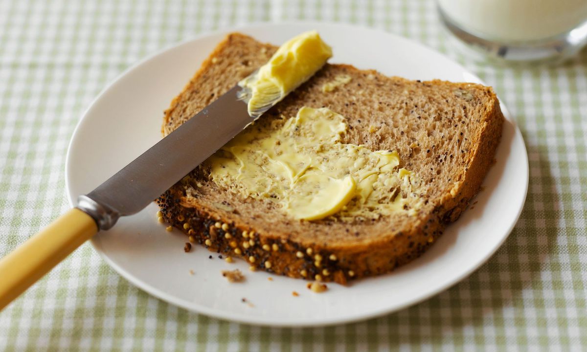 Butter spread on bread with knife