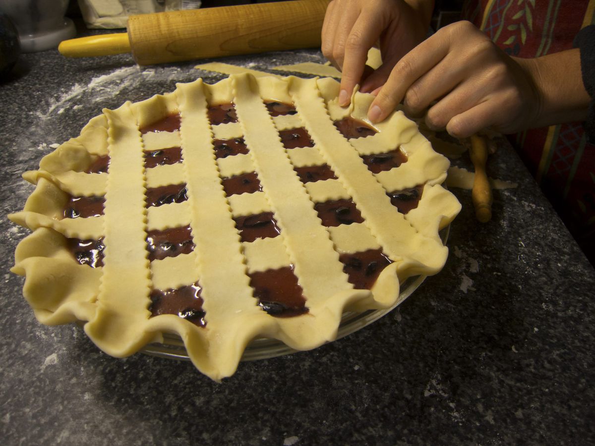 Hands Fitting Pie Dough into Pie Plate