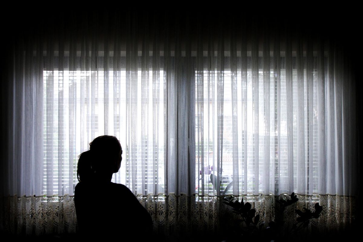 Silhouette of Woman Staring Out Window