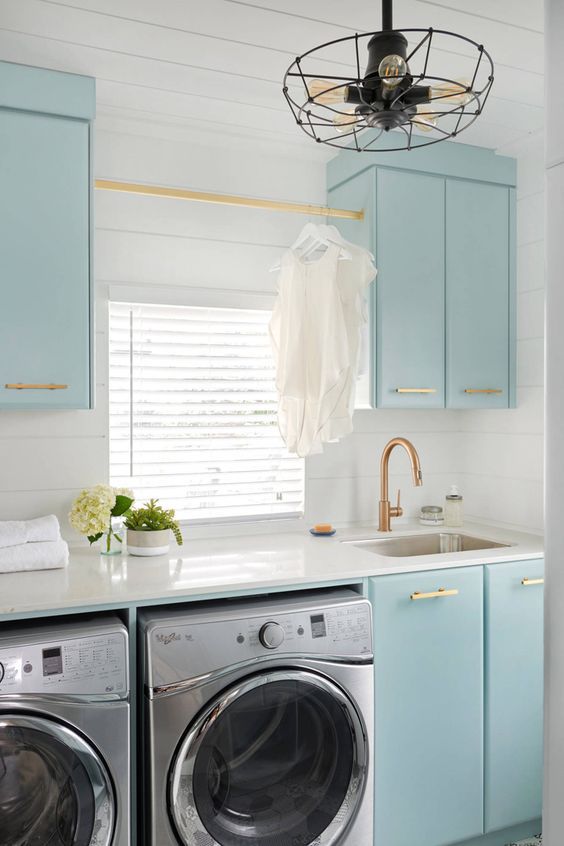 White Laundry Room with Light Blue Cabinets
