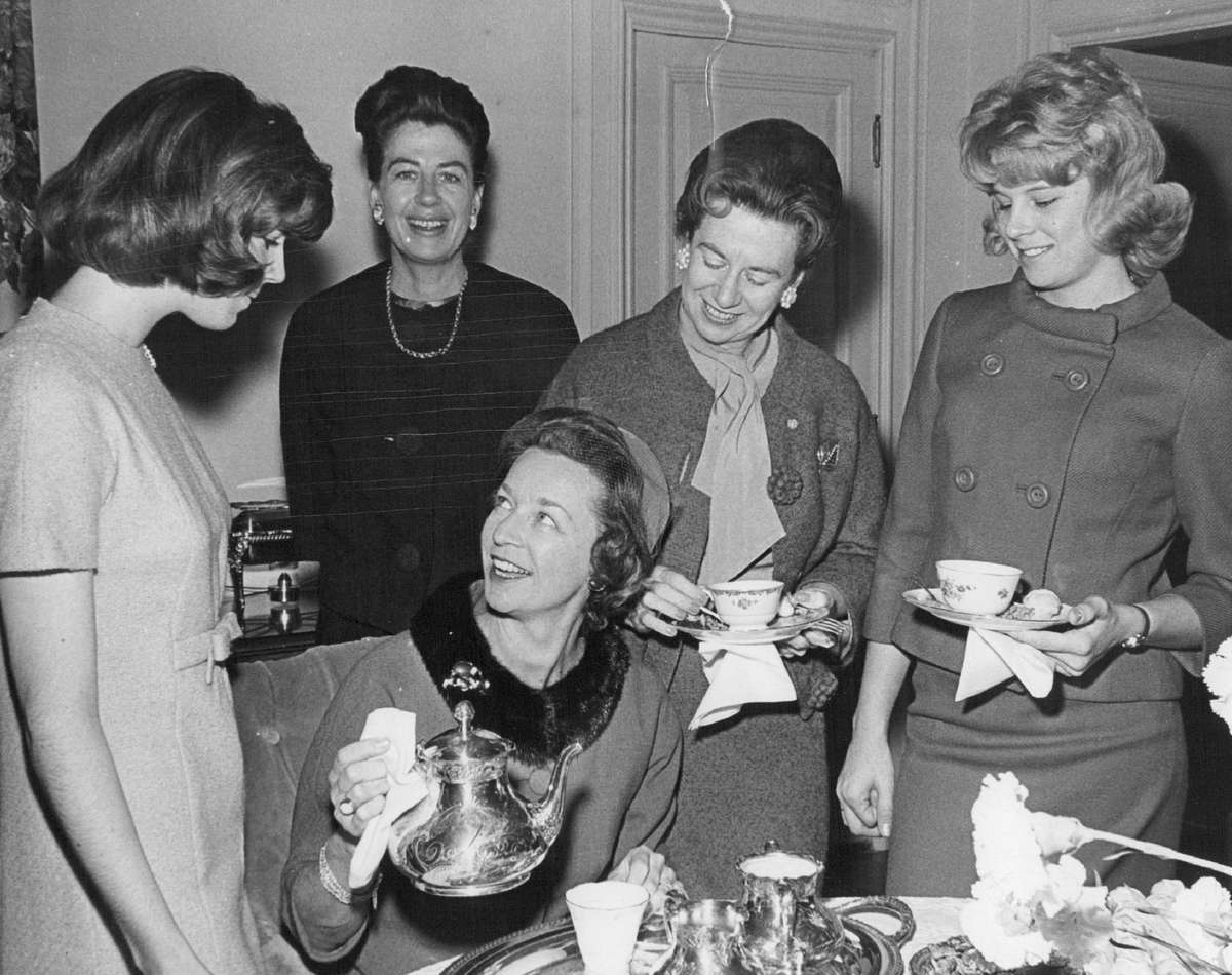 Woman Pouring Tea at Party