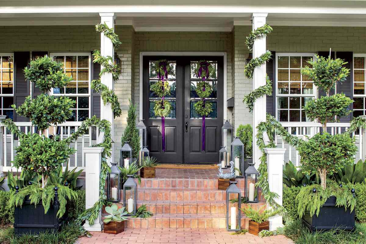 Front Door with 6 wreaths and garland wrapped porch posts