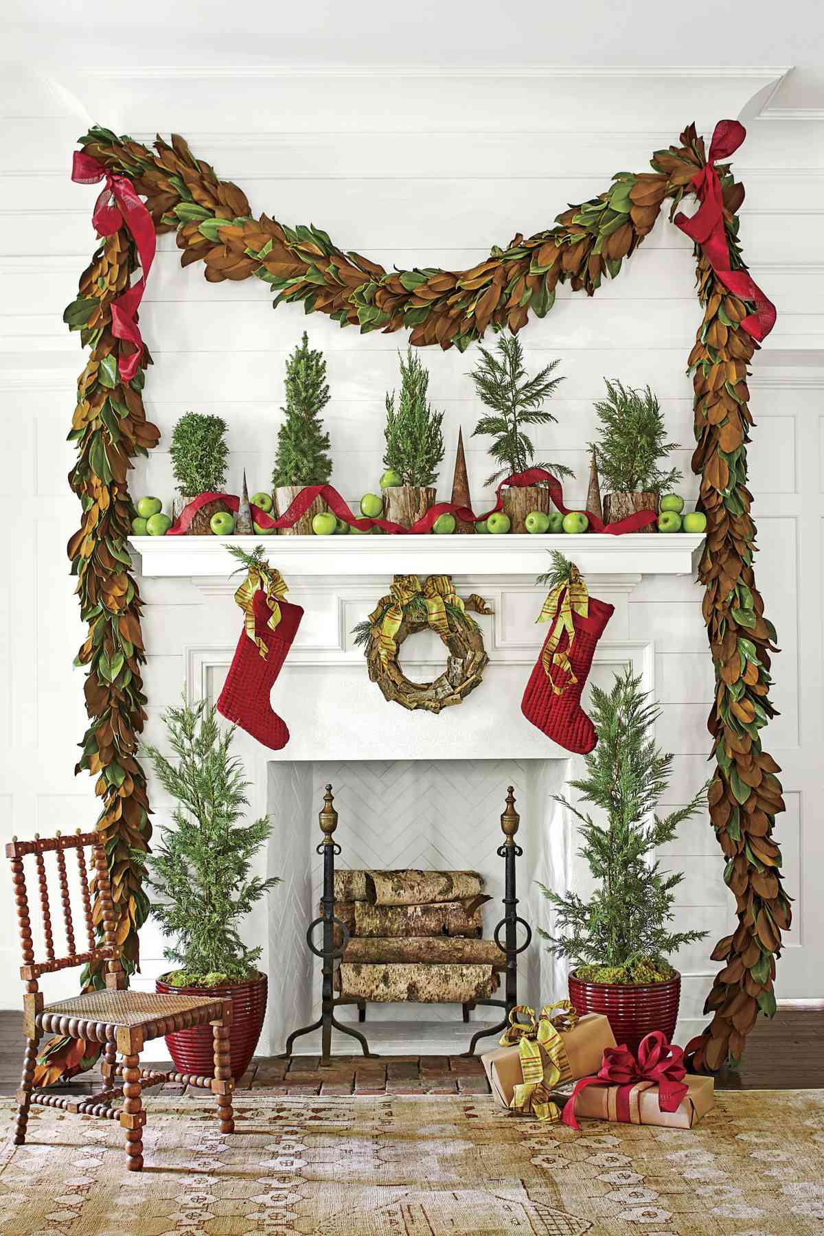 Magnolia Garland and Red Accents Around Fireplace