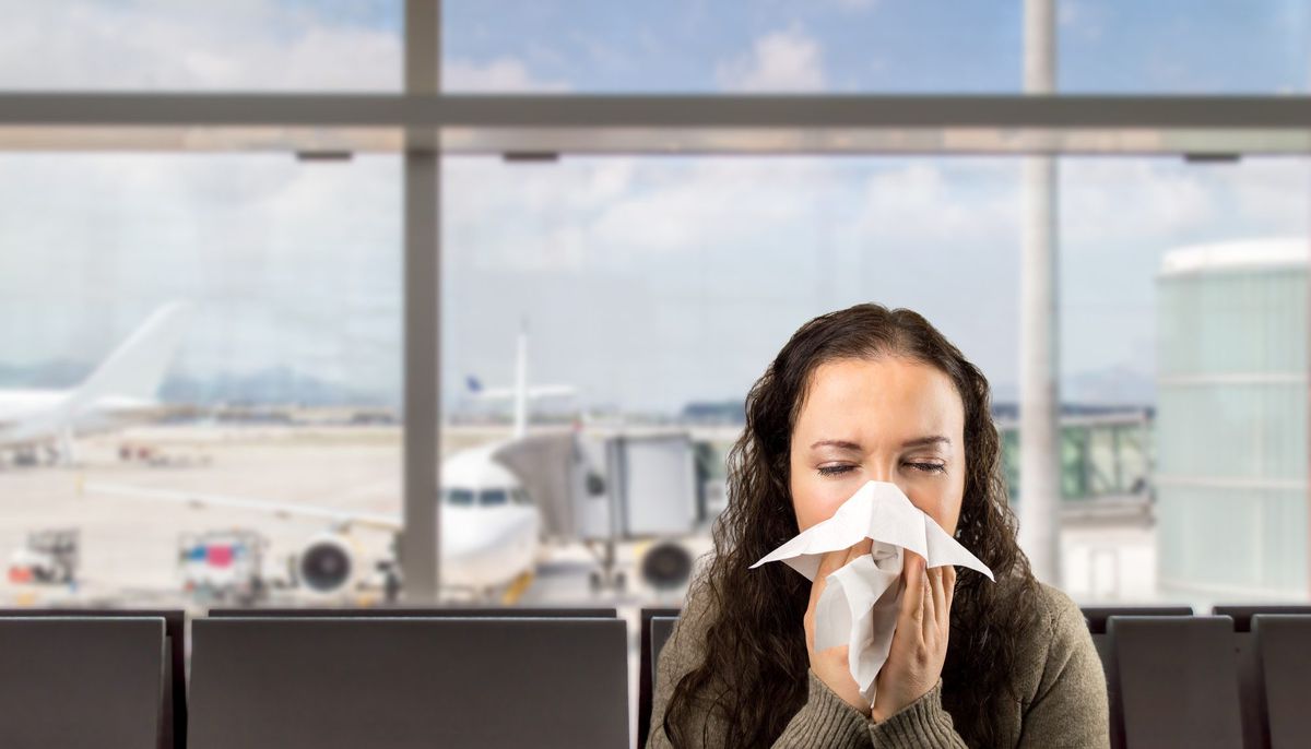 Woman Sneezing at Airport