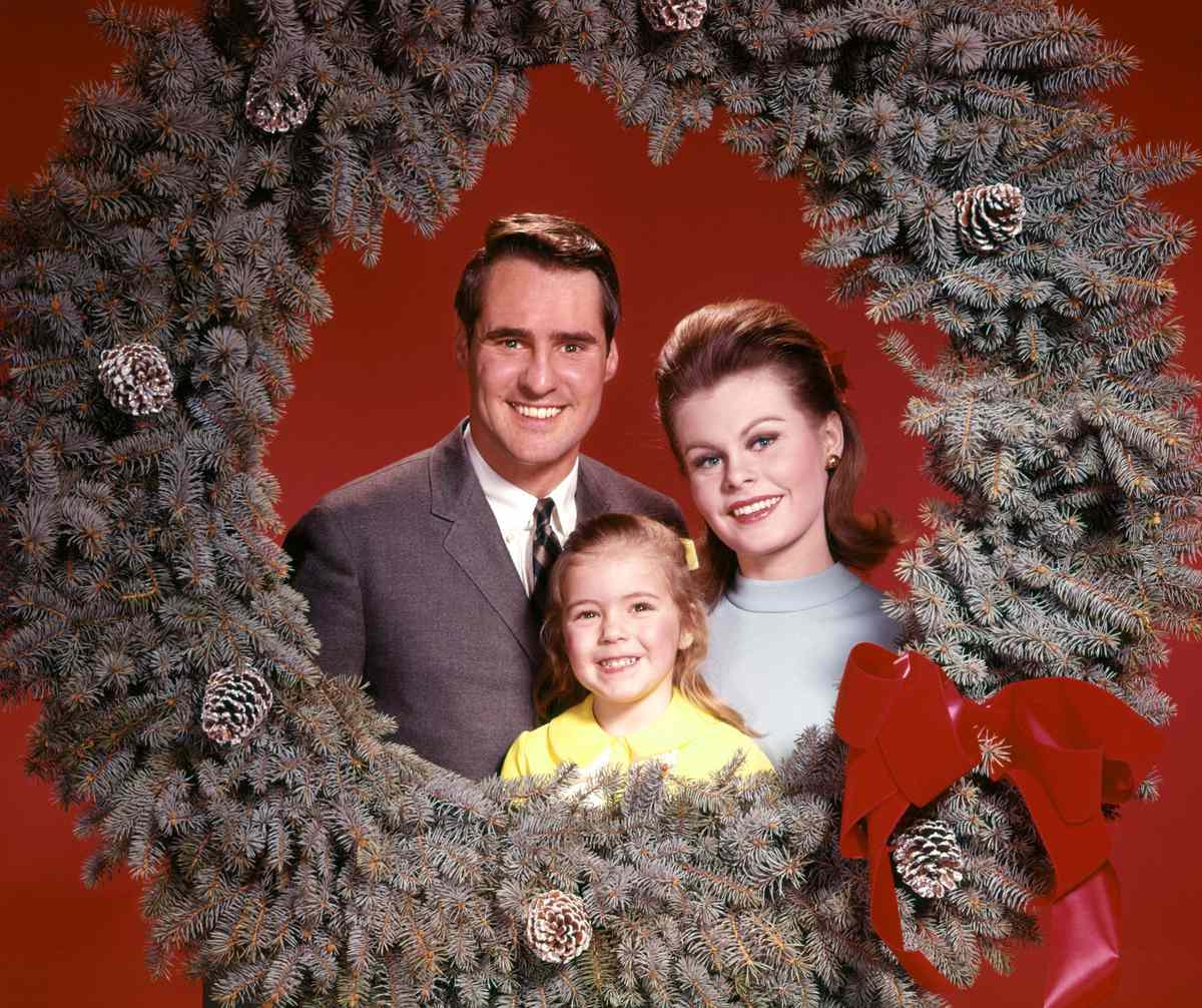 Happy Family Posing with Christmas Wreath