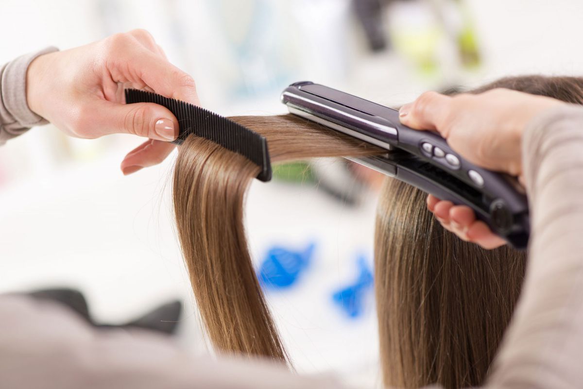 Straightening hair with flatiron