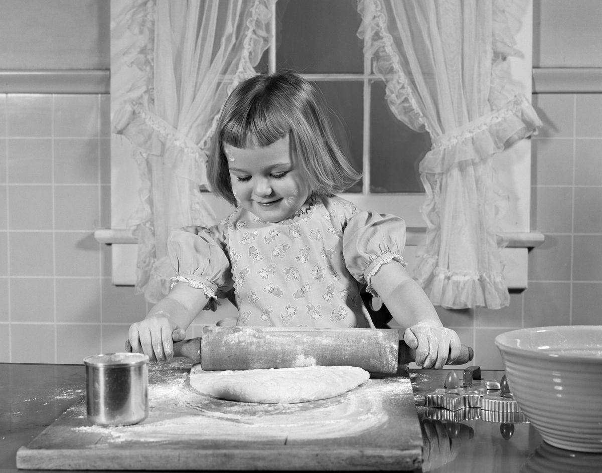 Young Girl Baking Rolling Out Dough