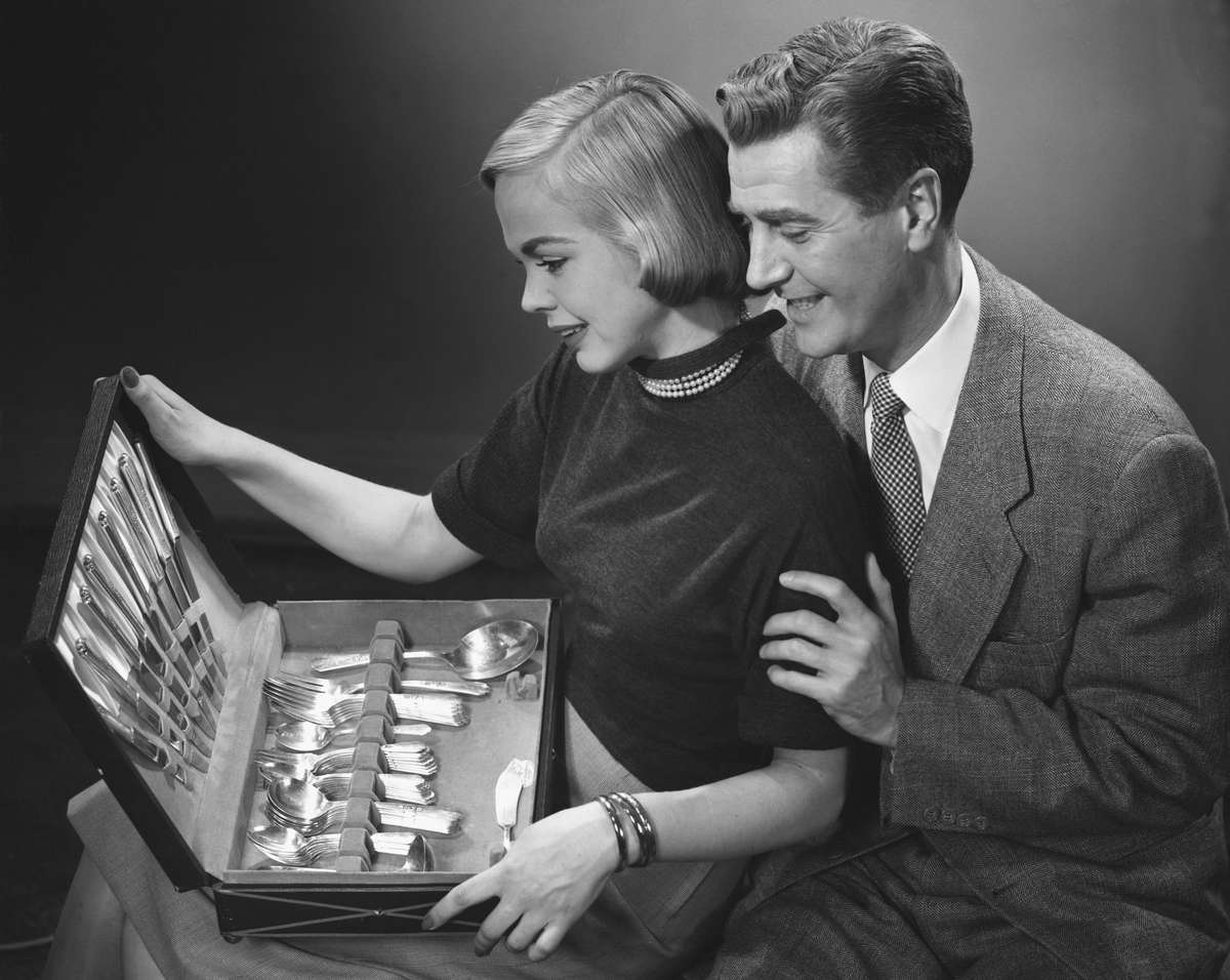 Couple admiring silverware (tout for "Why I Didn’t Want My Mom’s Silver Pattern")
