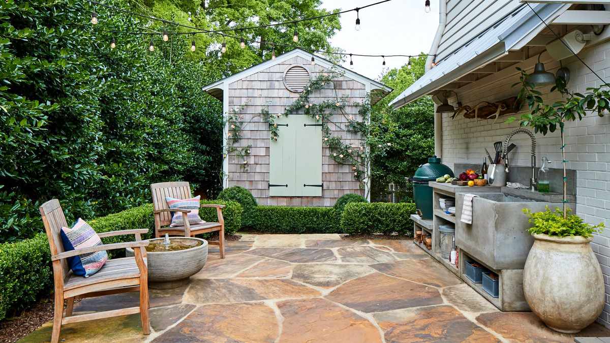 Outdoor Kitchen and Shed by Patio in Backyard