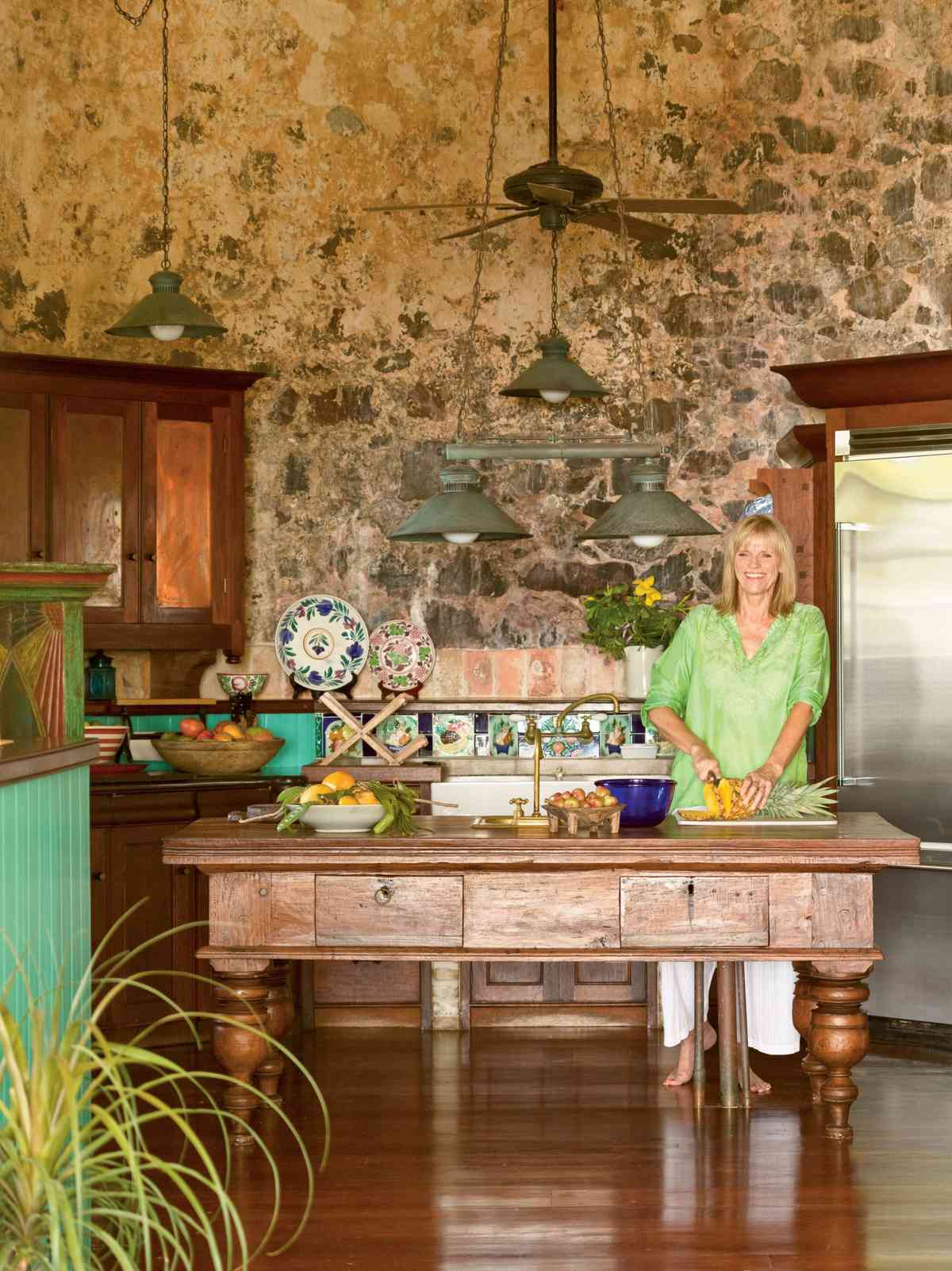 <p>This kitchen gets its distinctive look primarily from its location, at the base of a windmill tower on an old sugarcane plantation in the Caribbean. Recreate a similar island effect with natural wood pieces, lush vegetation, and bold floral accents in tropical shades of red, blue, and green.</p>
                            