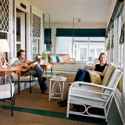 <p>A wide, screened-in porch extends this home's living space and gives year-round sheltered comfort. Plentiful seating, grass rugs, and a hanging swing give this porch a homey feel.</p>
                            
