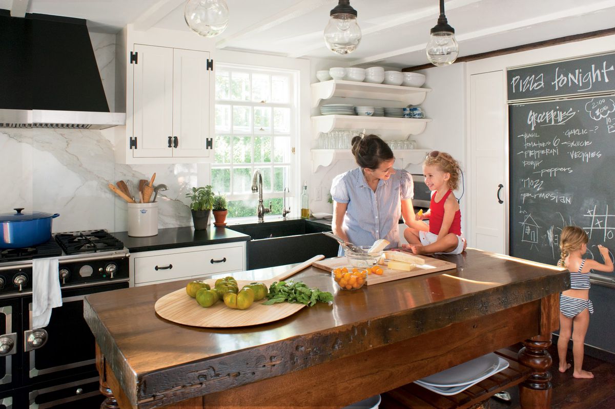 This restored Nantucket kitchen gets extra points for its fun and family-friendly chalkboard, where kids can draw and parents can record needed grocery items. The perfect-for-a-crowd island was constructed using salvaged wooden legs and a butcher block to