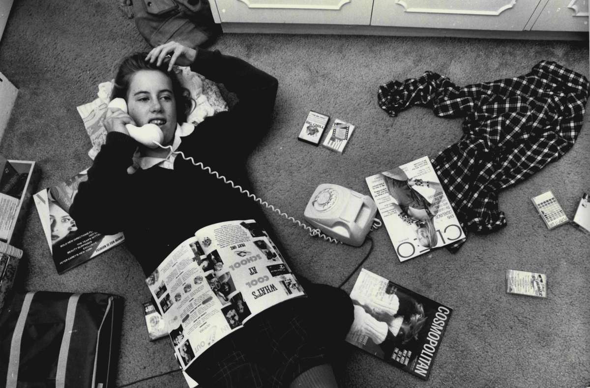 Teenager Laying on Floor Talking on Phone in the 1980s