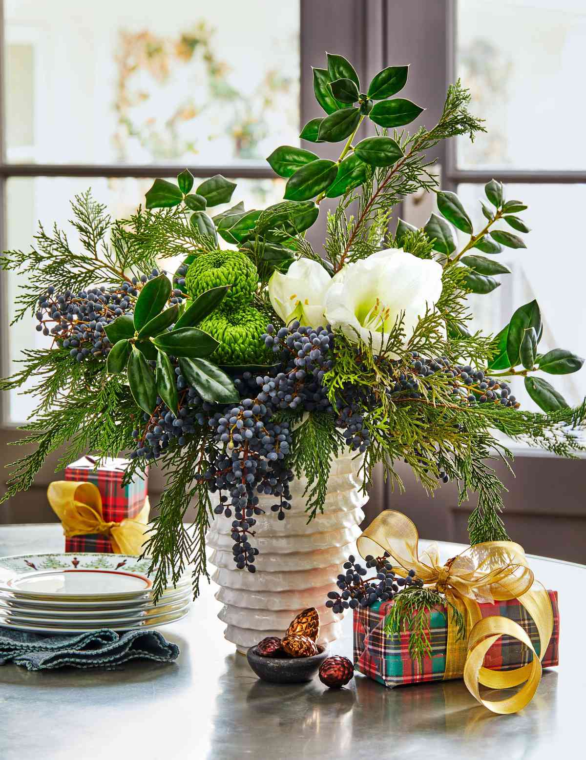 Holly, Cedar, and Privet Berry Arrangement with White Amaryllis and Green Mum flowers