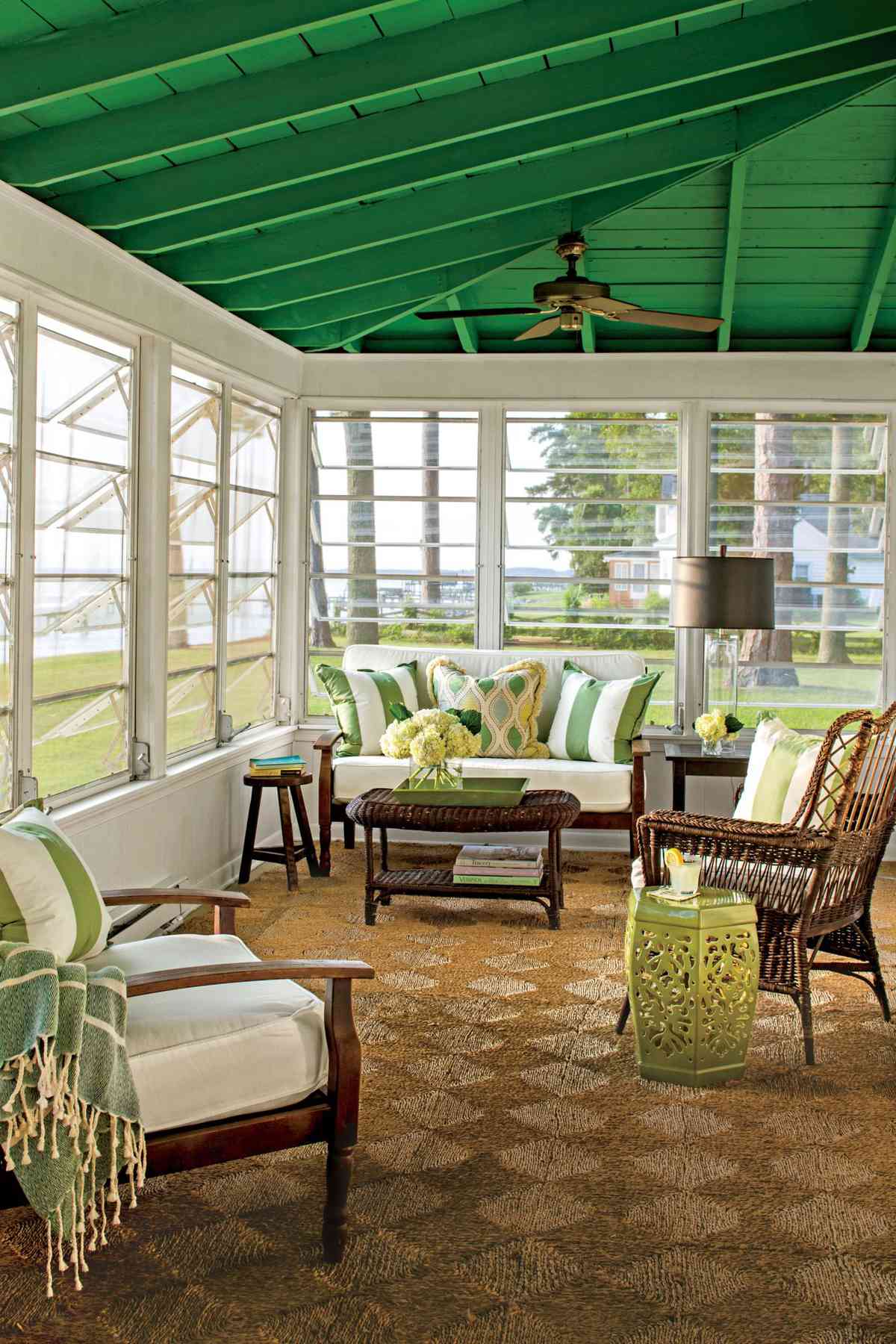 River house sunroom with green painted ceiling and hand-crank jalousie windows