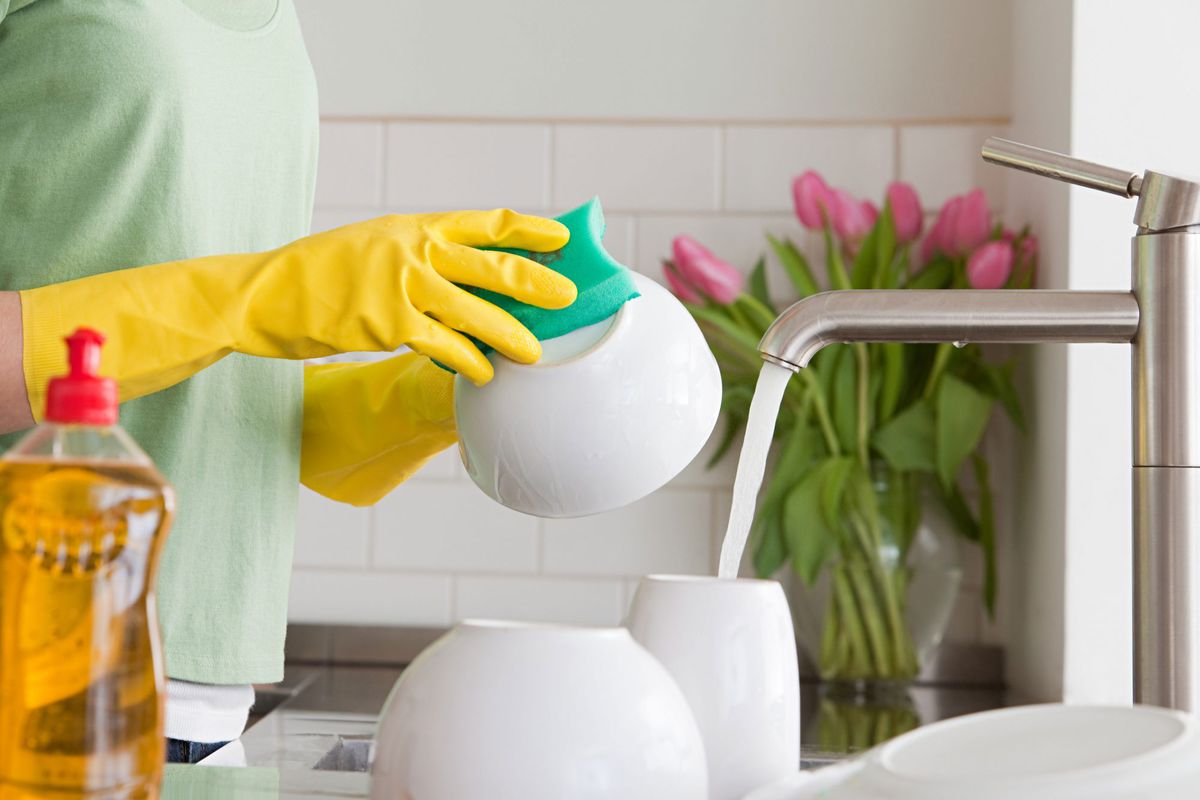 Hands at Sink Wearing Rubber Gloves Washing Dishes