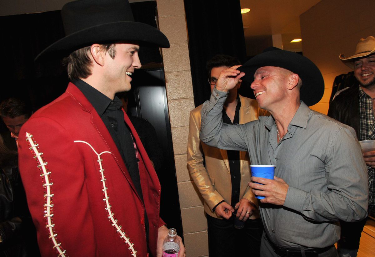 Actor Ashton Kutcher and musician Kenny Chesney backstage at the 47th Annual Academy Of Country Music Awards