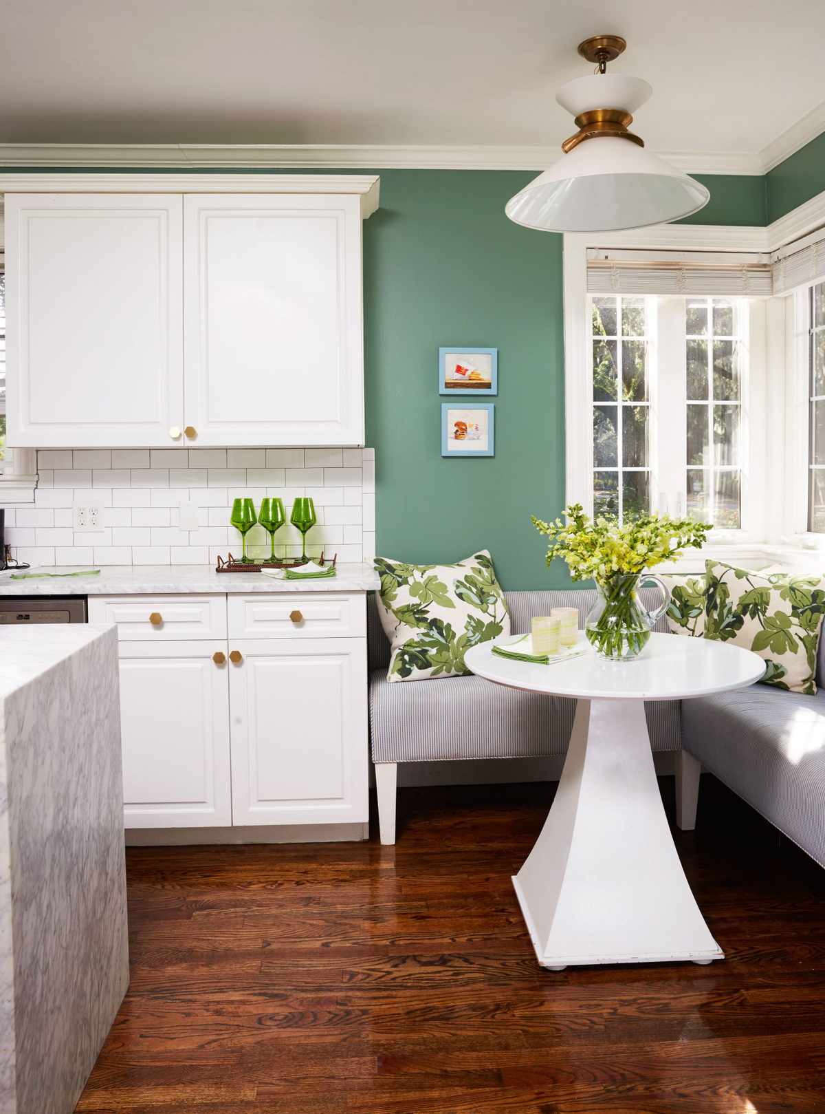 White Kitchen with green walls and corner breakfast nook
