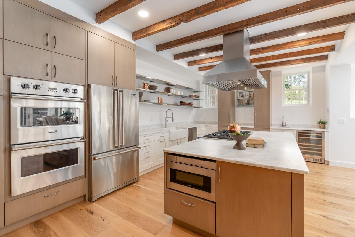 Large home kitchen with exposed beams and stainless steel applicances