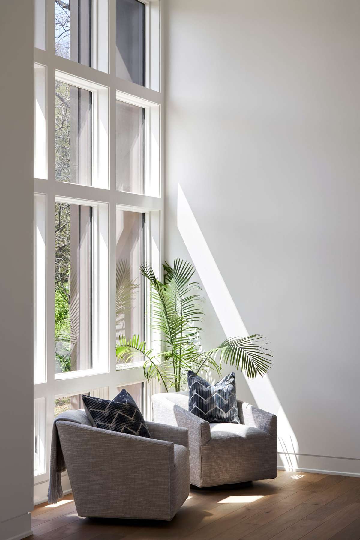 Light-filled Corner with Two Gray Swivel Chairs