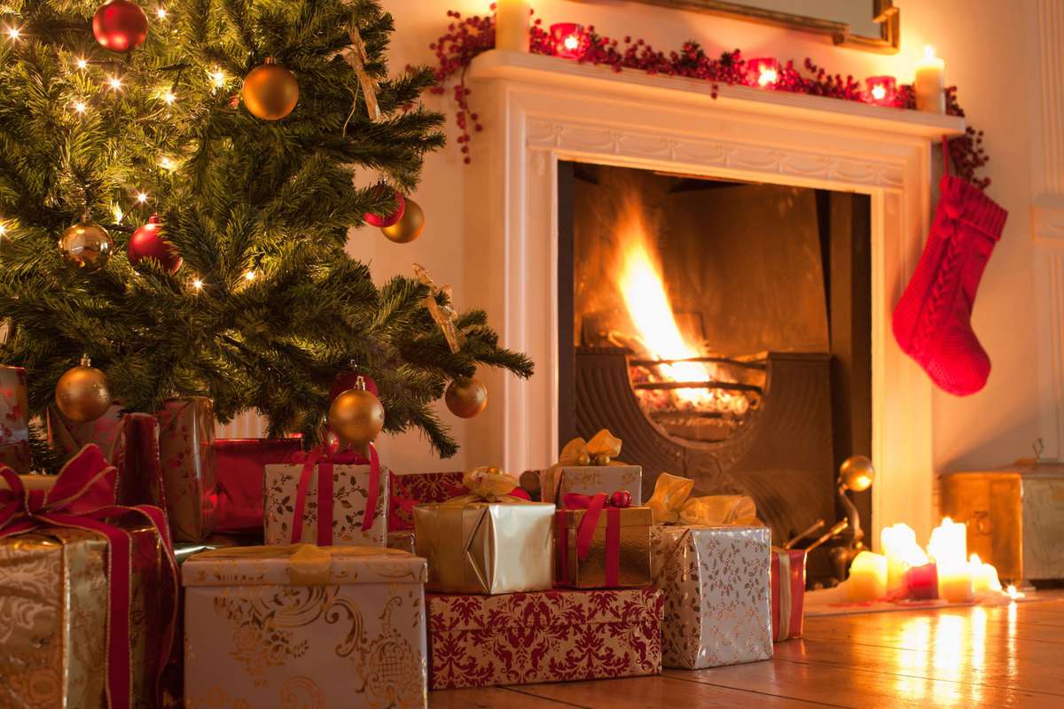 Fireplace with Nearby Christmas Tree, Stockings Hanging from Mantel, Presents, and Melted Candles