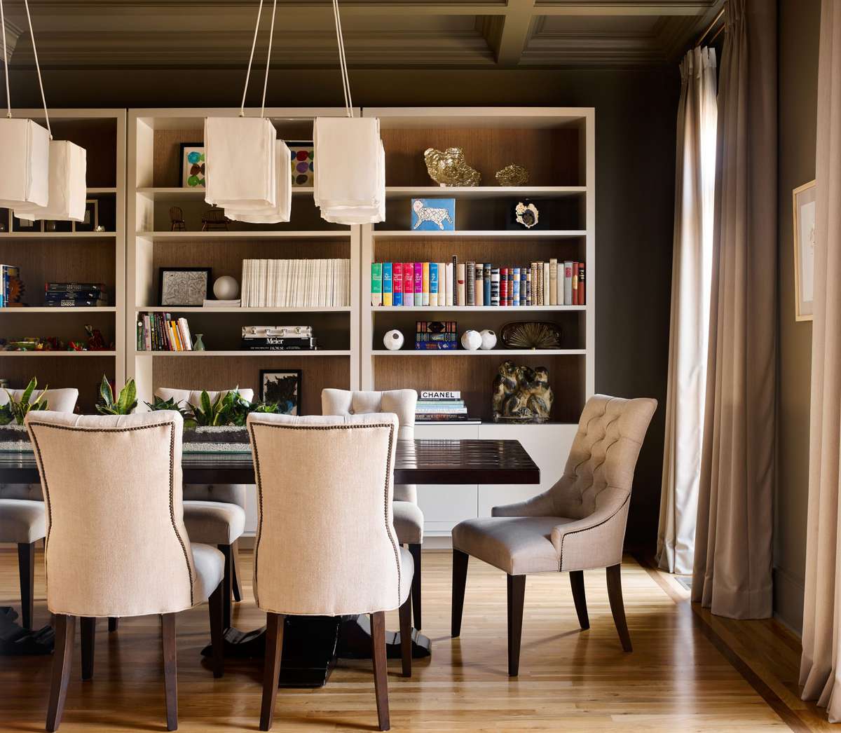 Brown Dining Room with Wall of Bookshelves