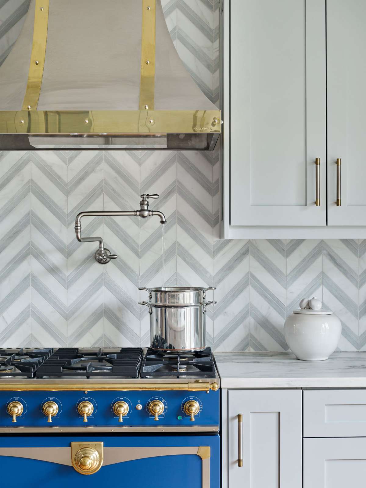 Mixed Finishes in Kitchen with Geometric Backsplash and Potfiller