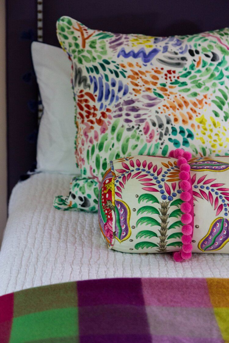 Bright Throw Pillows on Bed with White Quilt