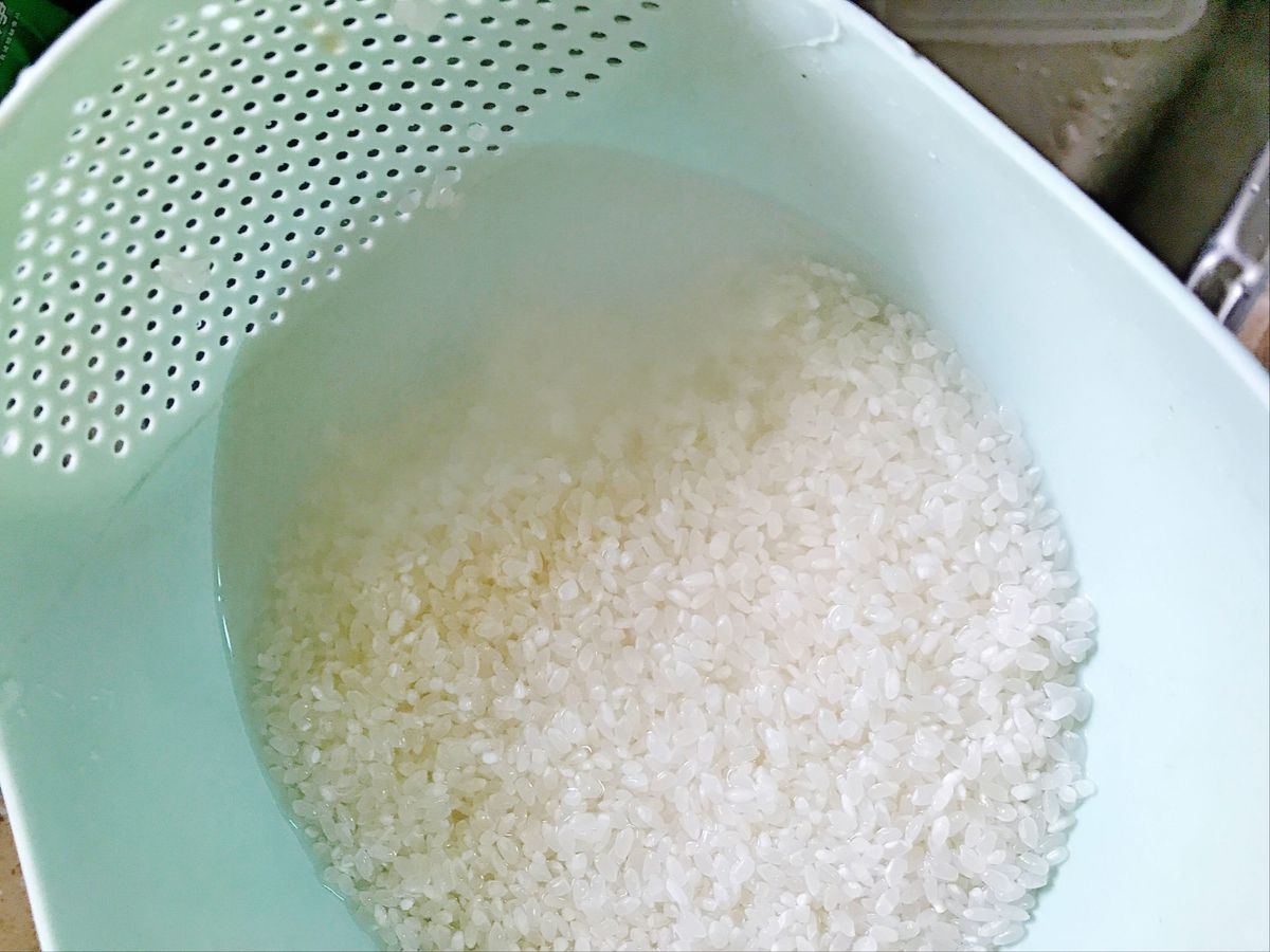 Rinsing Rice in Colander with Water